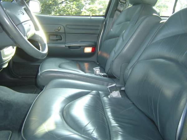 Gray leather car interior with bucket seats and a steering wheel