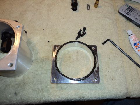 2004 Mercury Grand Marquis - Throttle body and adapter plate laid out with tools for installation.
