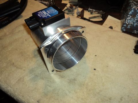 2004 Mercury Grand Marquis - A close-up view of a throttle body with an SCT tuning chip, likely for engine modification.