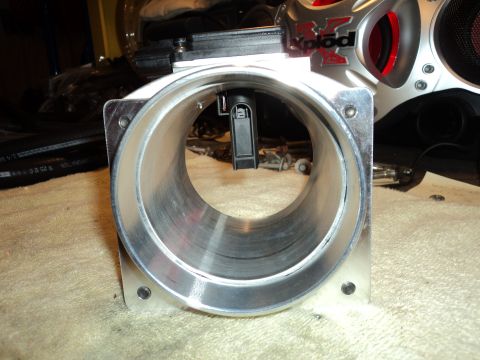 2004 Mercury Grand Marquis - Close-up of a throttle body, with a Sony Xplod speaker visible in the background.