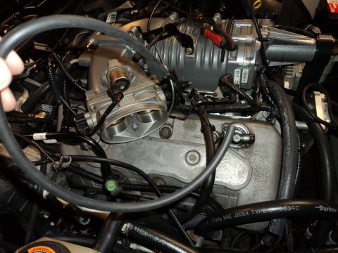 2004 Mercury Grand Marquis - Close-up view of a vehicle's engine bay, focusing on the supercharger and intake system.