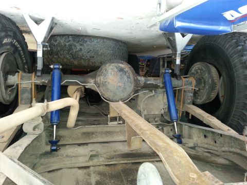 1982 Jeep Wagoneer - Close-up of the rear axle and suspension system of a vehicle.