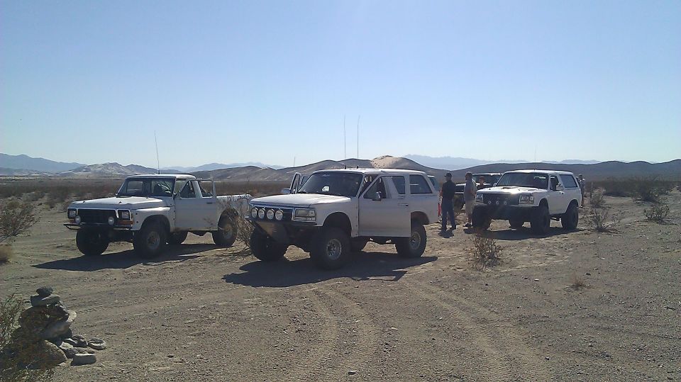 White 1996 Ford Bronco with off-road modifications parked in desert