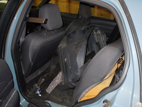 2001 Ford Crown Victoria - Disassembled interior of a car, showing exposed foam and removed panels.