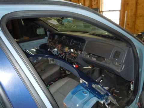 2001 Ford Crown Victoria - The interior of a car is shown with the dashboard disassembled, revealing wiring and internal components.
