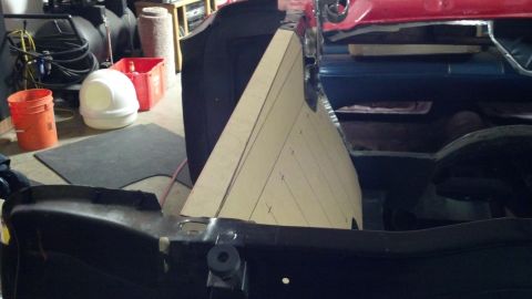 1964 Ford Fairlane - A cardboard template is placed inside a car's interior, with another vehicle visible in the background.