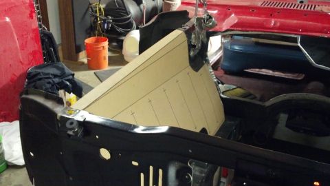 1964 Ford Fairlane - A cardboard template is positioned in the engine bay of a car, possibly for custom fabrication.