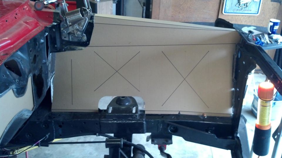 car firewall with cardboard template marked with lines and Xs