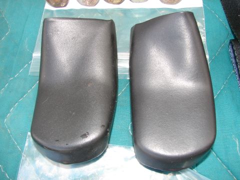 1973 Ford Ranchero - Two black plastic parts are shown, likely interior components from a vehicle.