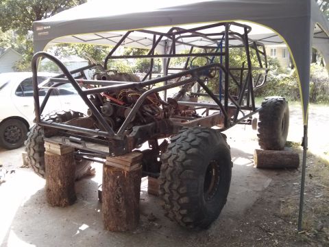 1986 Ford Bronco - This custom off-road buggy is undergoing construction, supported by logs under its frame.