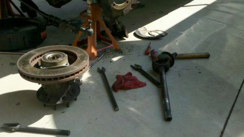 1997 Dodge 3500 - Vehicle brake rotor and suspension components laid out for repair work.