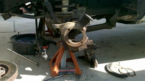 1997 Dodge 3500 - Vehicle undergoing front end repair, with suspension components disassembled and tools laid out.