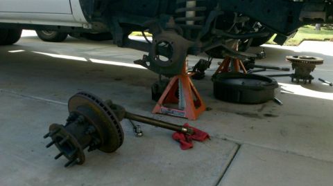 1997 Dodge 3500 - Front end components of a truck are disassembled and laid out on the ground.
