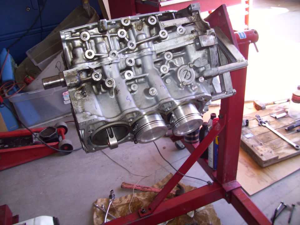 Engine block on a stand, showing pistons inside cylinders