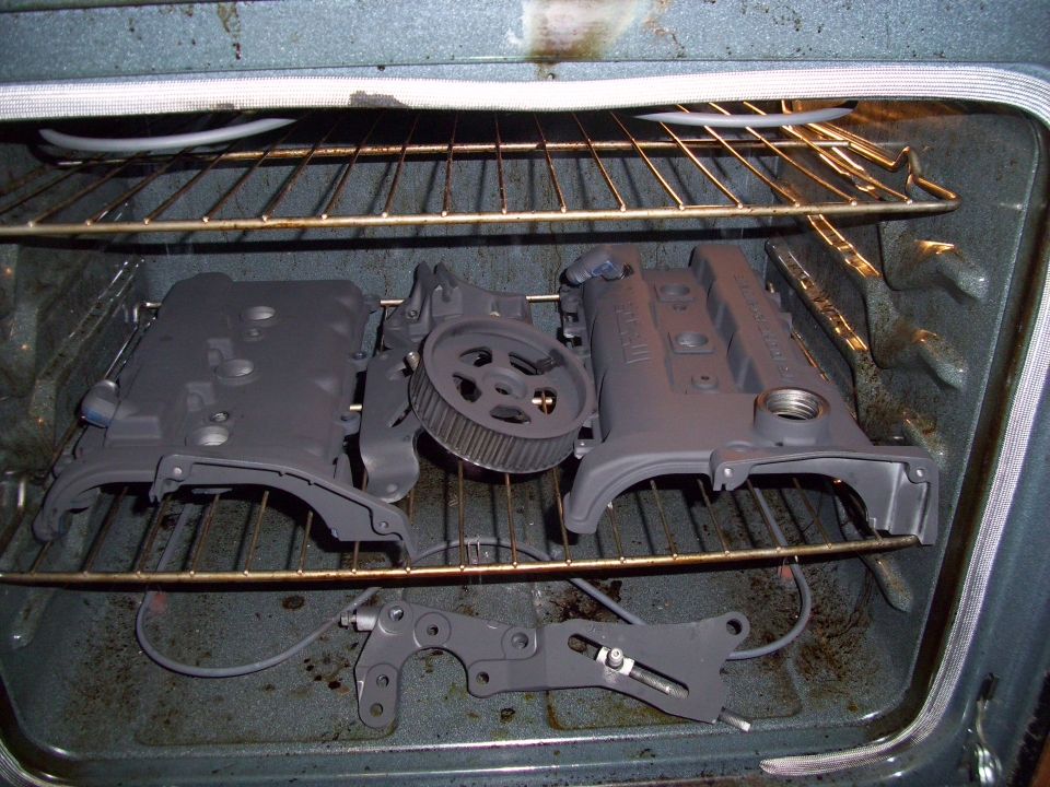 Engine parts drying in an oven on racks