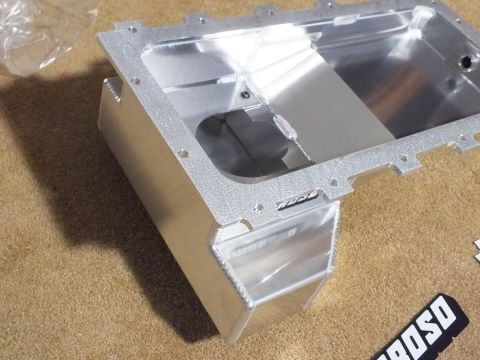 2003 Ford Crown Victoria - Fabricated aluminum Moroso oil pan with a deep front sump, viewed into its open interior showing baffling, on carpet.