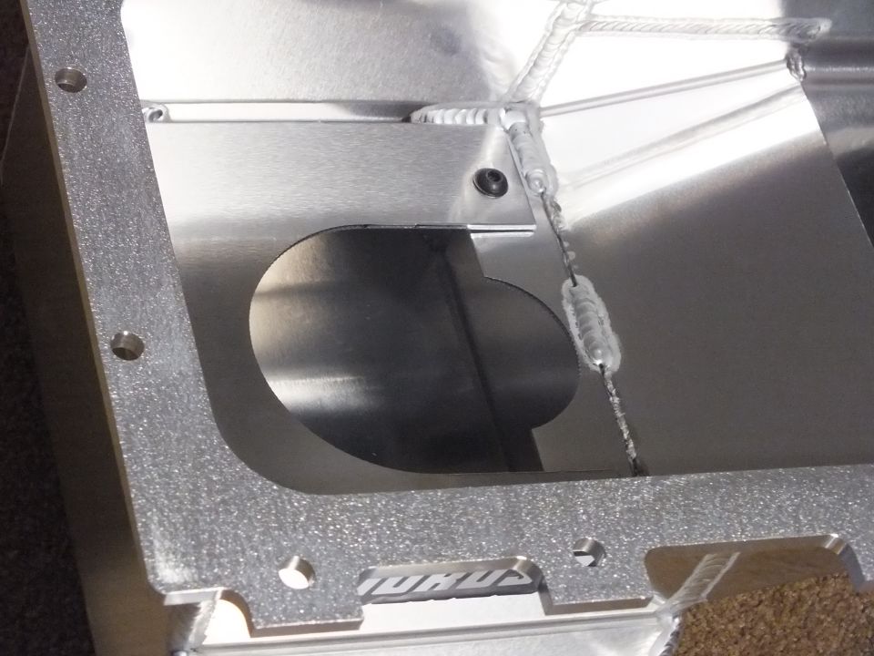 Close-up of windage tray hole and welded baffle inside aluminum oil pan