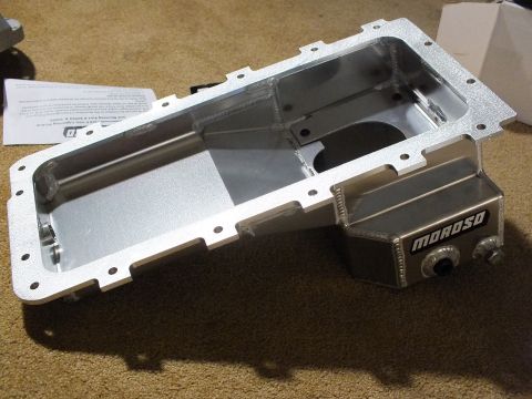 2003 Ford Crown Victoria - Cast-finish aluminum Moroso oil pan with an offset side sump shown from above beside a printed instruction sheet.