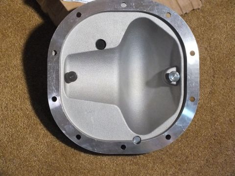 2003 Ford Crown Victoria - Interior view of a cast aluminum differential cover revealing the deep cavity, machined flange, and threaded adjuster boss.