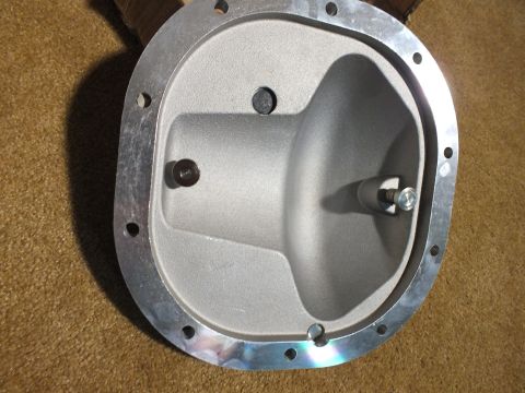 2003 Ford Crown Victoria - Inside view of a cast aluminum differential cover showing the bell-shaped cavity, threaded adjuster boss, and bolt flange.