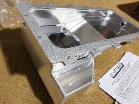 2003 Ford Crown Victoria - Fabricated aluminum Moroso oil pan with deep sump, viewed into its baffled interior, with a printed instruction sheet alongside.