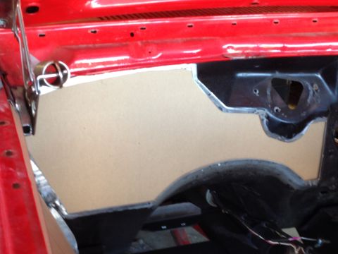 1964 Ford Fairlane - A custom-cut insulation panel is being installed on the firewall of a vehicle.