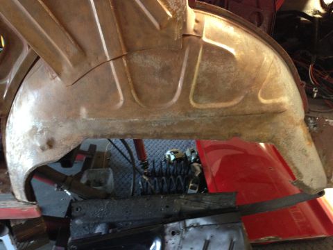 1964 Ford Fairlane - Close-up view of a heavily rusted interior wheel well, showing structural details and some surrounding components.
