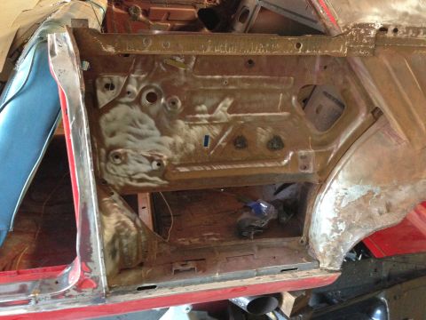 1964 Ford Fairlane - The interior of a car door frame is visible, with signs of rust and repair work.