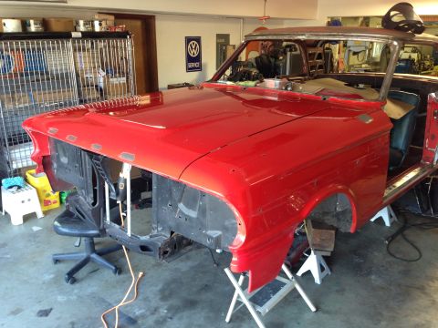 1964 Ford Fairlane - A red 1964 Ford Fairlane is shown in a garage, appearing to be in the process of restoration with its front end disassembled.