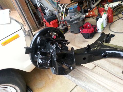 1991 Ford Festiva - A close-up view of a car's suspension component, likely a rear axle assembly, is shown.