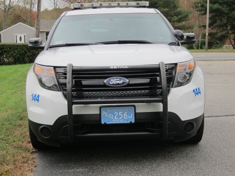 2001 Ford Crown Victoria - This police SUV features a light bar on the roof and the number 144 on its front fenders.