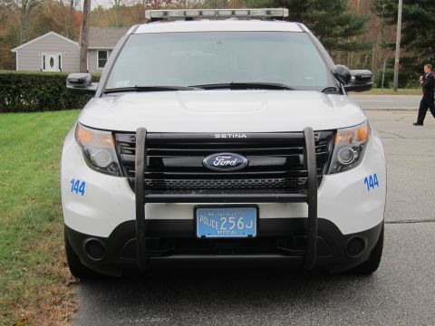 2001 Ford Crown Victoria - A white Ford police SUV is parked on a street, with a Massachusetts license plate visible.