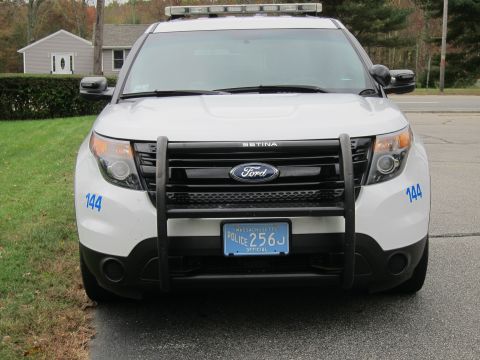 2001 Ford Crown Victoria - This police SUV features a push bar and light bar, indicating its law enforcement purpose. The Massachusetts license plate is clearly visib…