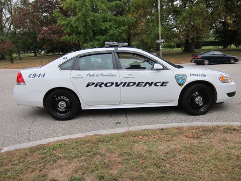 2001 Ford Crown Victoria - Side view of a Providence police car, with another vehicle visible in the background.