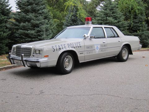 2001 Ford Crown Victoria - Photograph of a Rhode Island State Police Chrysler sedan, not a technical document.