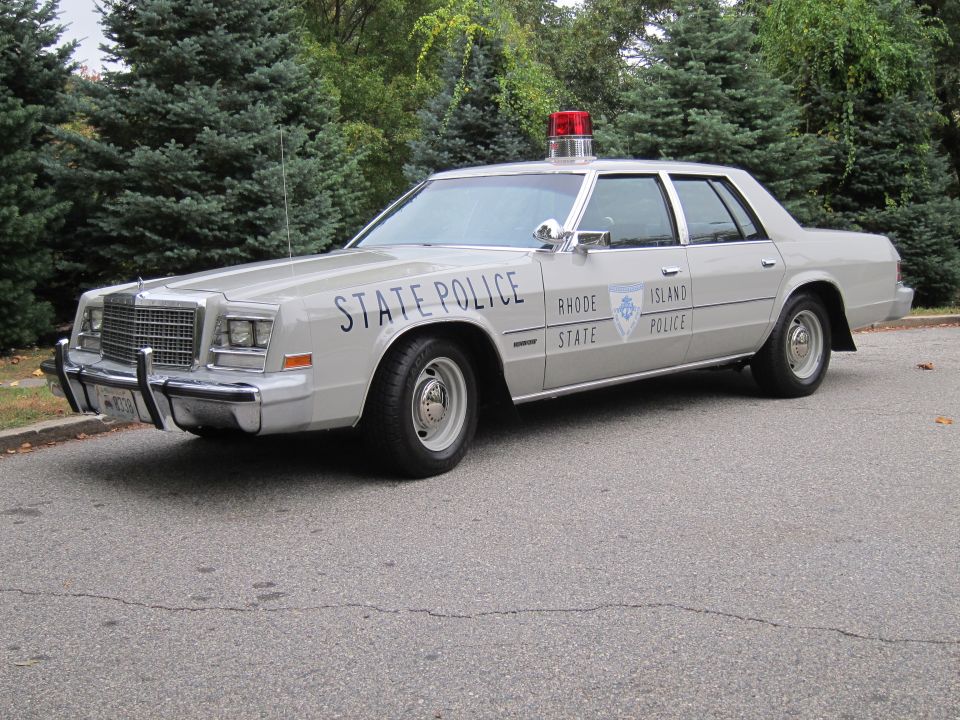 Silver Rhode Island State Police Chrysler Newport sedan parked outdoors