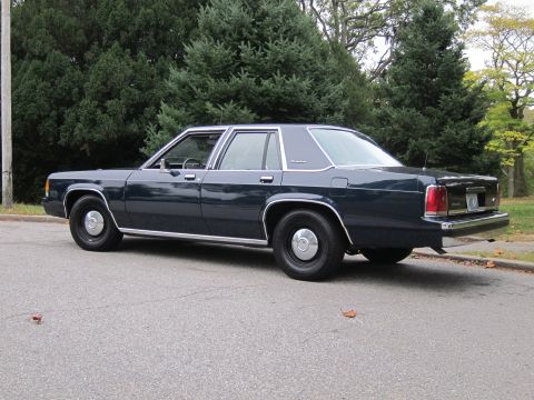 2001 Ford Crown Victoria - Photograph of a dark Ford Crown Victoria sedan, not a technical document.