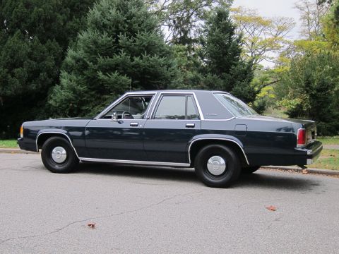 2001 Ford Crown Victoria - Photograph of a dark Ford Crown Victoria sedan, not a technical document.