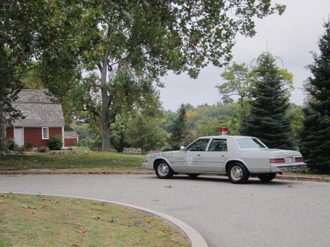2001 Ford Crown Victoria - Photograph of a Rhode Island State Police Chrysler cruiser parked outdoors, not a technical document.