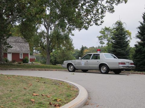 2001 Ford Crown Victoria - Photograph of a Rhode Island State Police Chrysler cruiser, not a technical document.