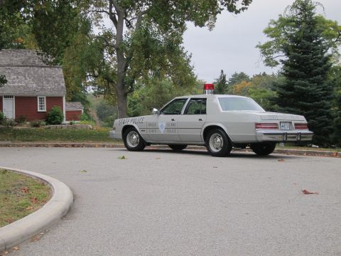2001 Ford Crown Victoria - Photograph of a Rhode Island State Police Chrysler cruiser, not a technical document.