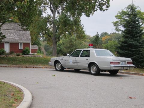 2001 Ford Crown Victoria - Photograph of a Rhode Island State Police Chrysler cruiser, not a technical document.