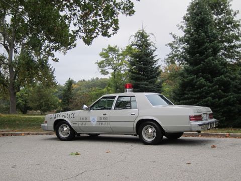 2001 Ford Crown Victoria - Photograph of a Rhode Island State Police Chrysler cruiser, not a technical document.
