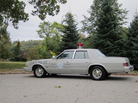 2001 Ford Crown Victoria - Photograph of a silver Rhode Island State Police sedan, not a technical document.