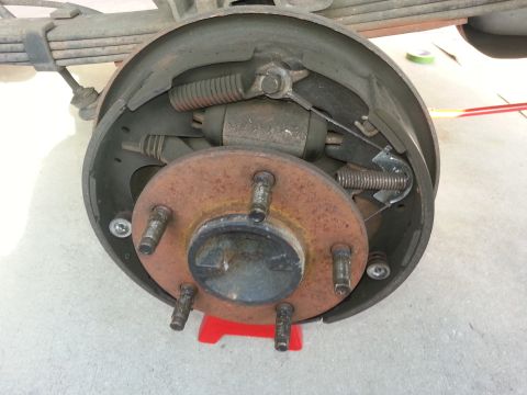 1994 Ford Bronco - Photograph of a disassembled rear drum brake showing shoes, wheel cylinder, and the wheel hub.