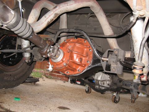 1994 Ford Bronco - The underside of a 1994 Ford Bronco shows the rear differential, exhaust pipes, and suspension components. The rear differential housing is…