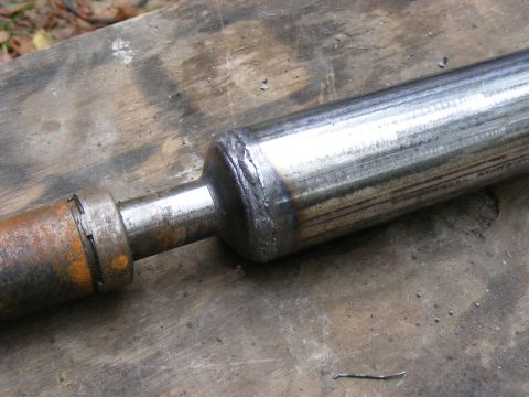 Welded metal shaft on a wooden surface