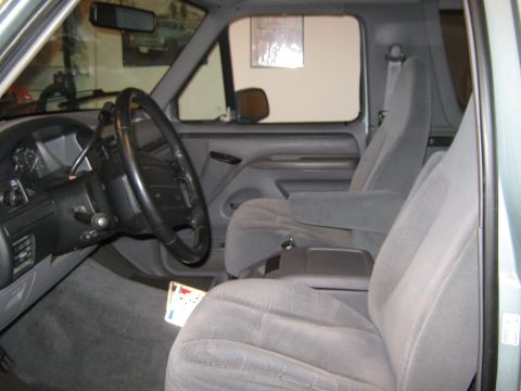 1996 Ford Bronco - The interior of a 1996 Ford Bronco is visible, including the dashboard and seats.