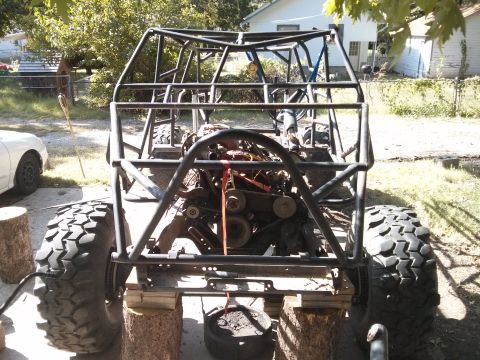 1986 Ford Bronco - Custom buggy chassis with engine installed, raised on blocks for work.
