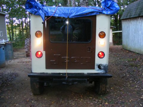 Jeep CJ-5 rear, cream and brown, with blue tarp on roof